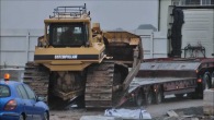 Caterpillar Bulldozer Slides Down Off A Truck