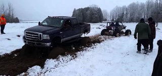 Surprisingly Powerful Buggy Pulls out Mega Truck from Snow Bog